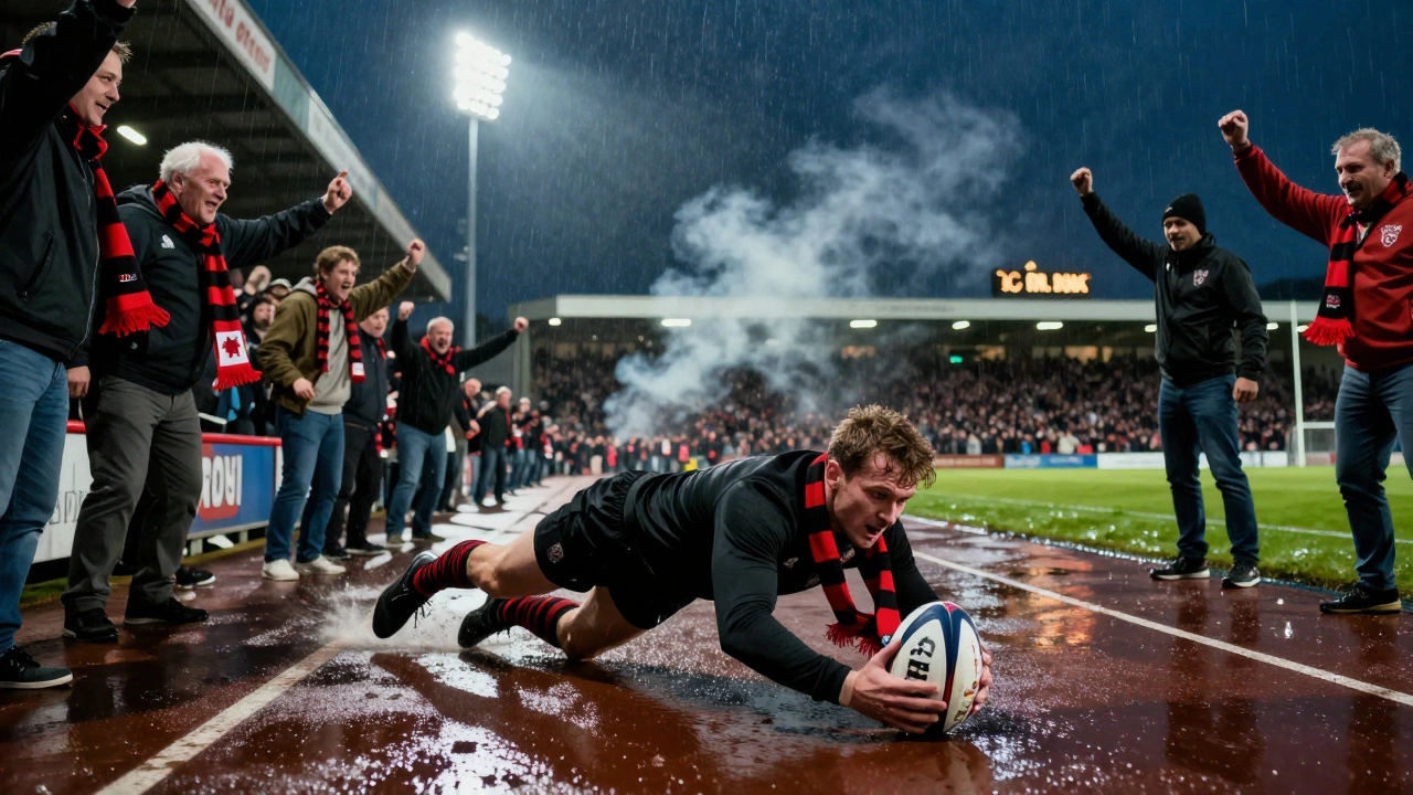 A packed Welsh rugby stadium at night, fans cheering as a player dives for the try line in the rain.